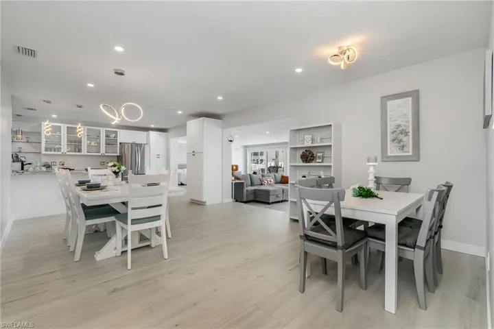 Dining space featuring recessed lighting, a chandelier, light wood grain tile floors