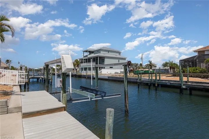 Dock featuring boat lift and a water view