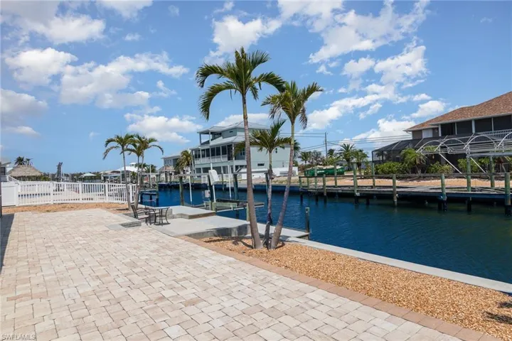 Large paver area featuring Dock and water view
