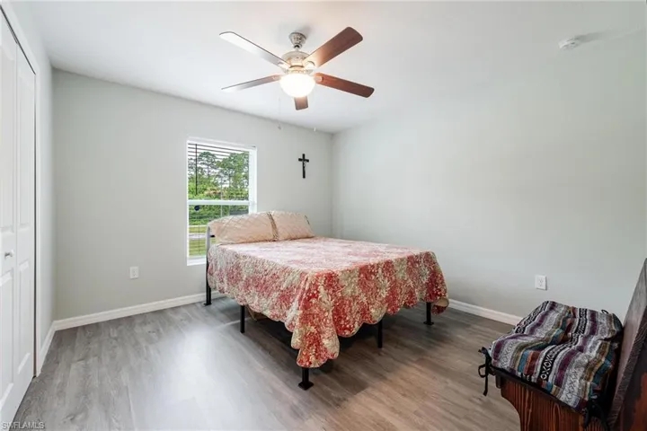 Bedroom featuring light wood-type flooring, ceiling fan, and a closet