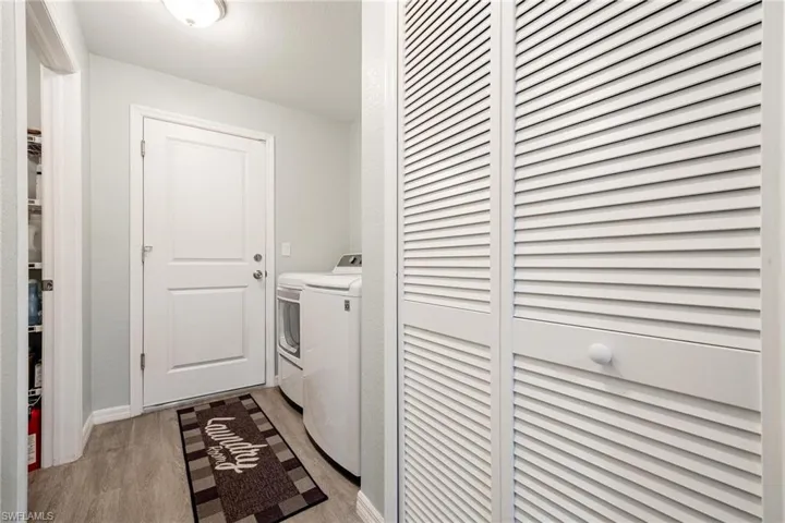 Laundry room featuring light hardwood / wood-style flooring and independent washer and dryer