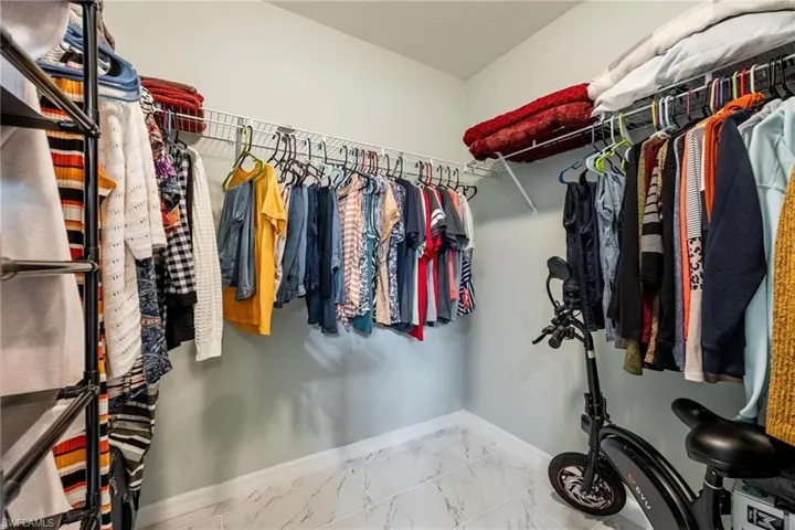 Spacious closet featuring tile patterned flooring