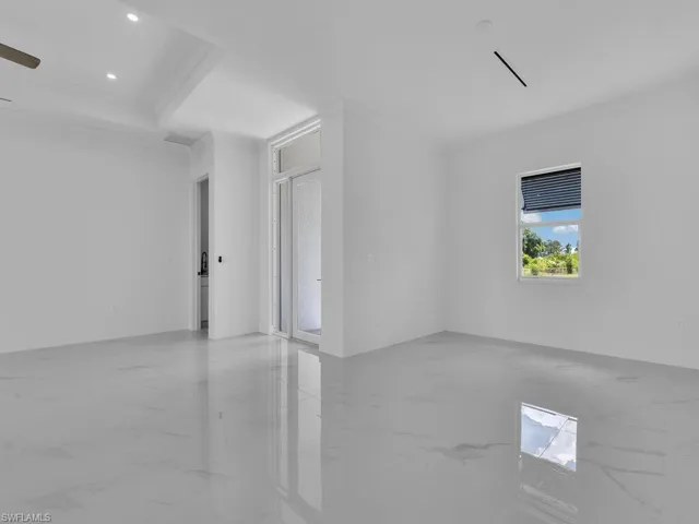 Spare room featuring ornamental molding and ceiling fan