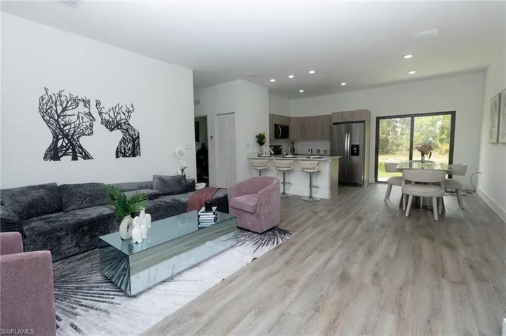 Living room with light wood-style floors and recessed lighting