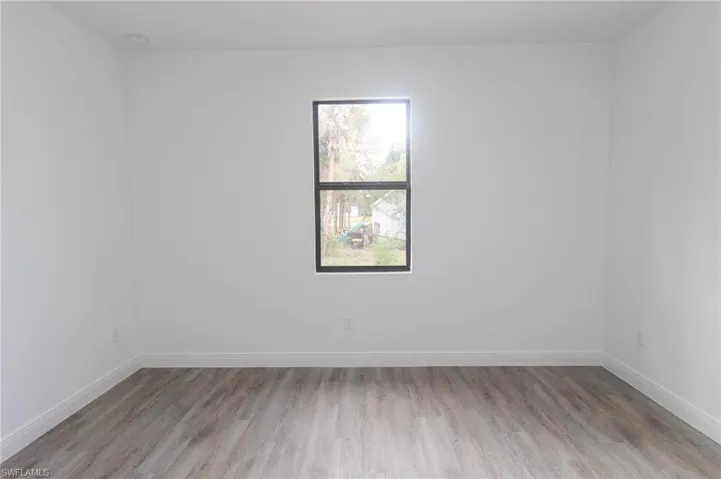 Master bedroom with light vinyl flooring.