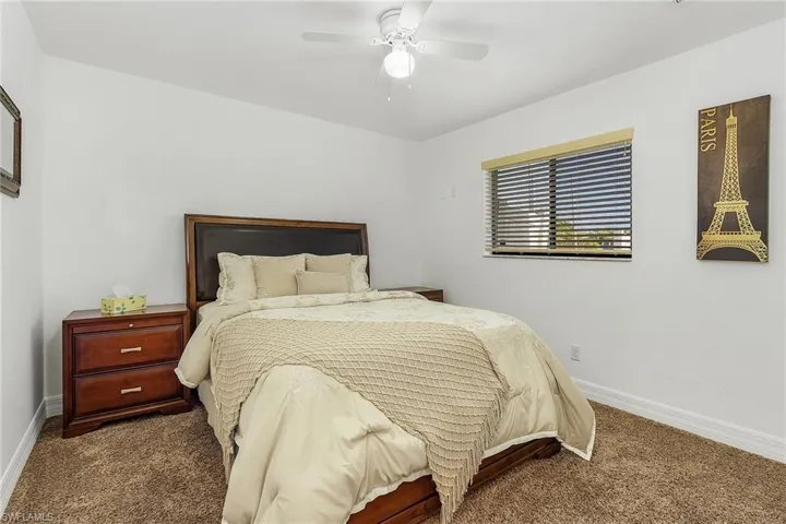 Carpeted bedroom with ceiling fan