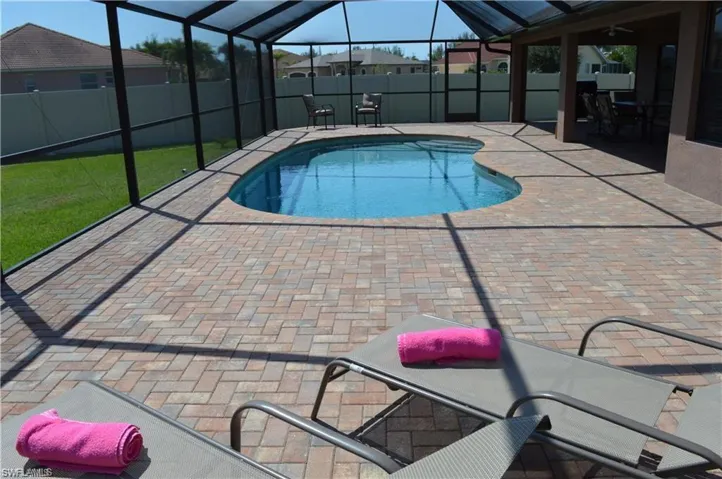 View of pool with a patio and a lanai
