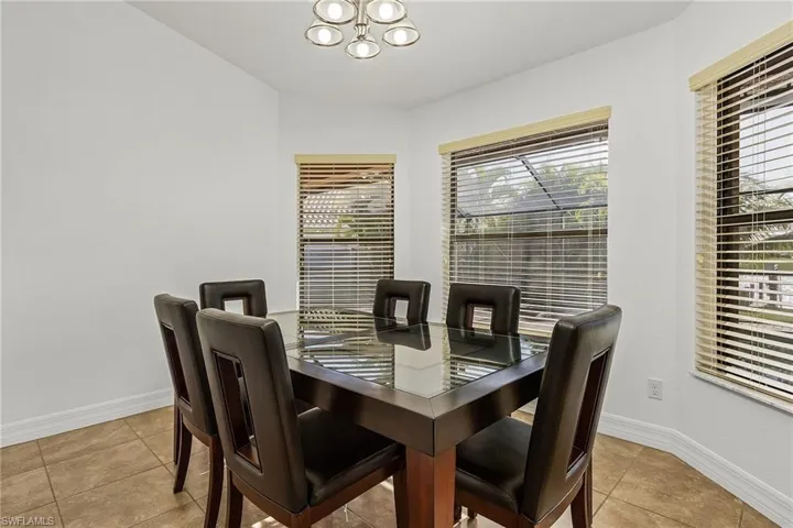 Tiled dining space featuring an inviting chandelier