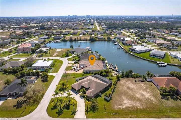 Birds eye view of property with a water view