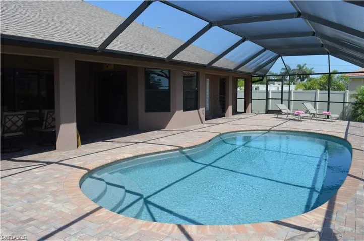 View of pool featuring a patio area and a lanai