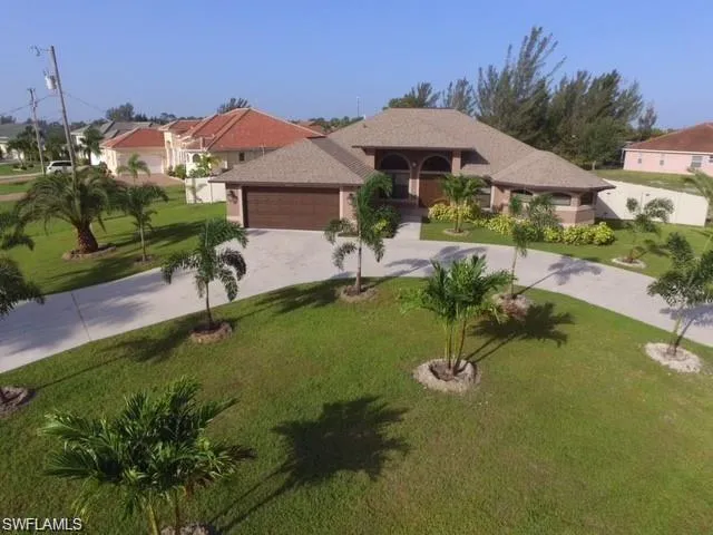 Mediterranean / spanish-style home with a front yard and a garage