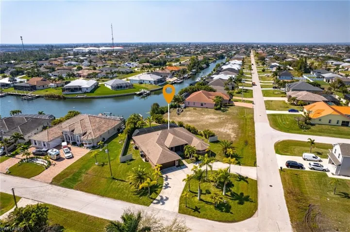 Birds eye view of property with a water view