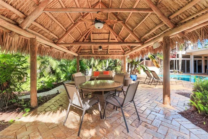 Tiki hut features covered dining and conversation area
