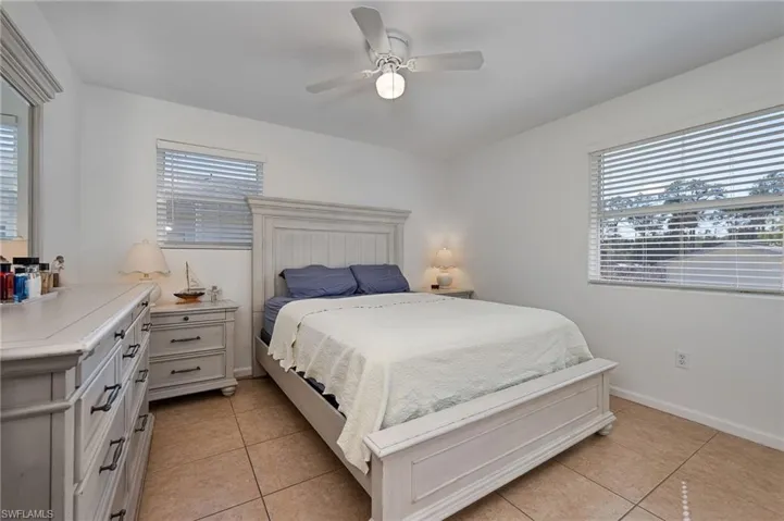 Bedroom featuring light tile patterned floors and a ceiling fan