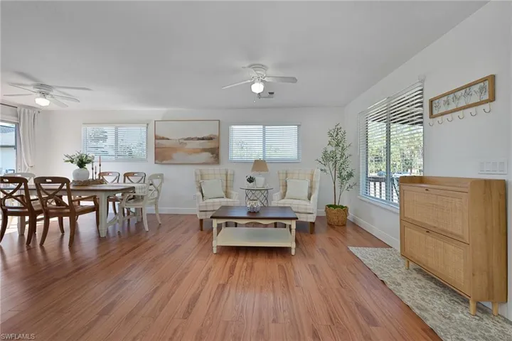 Living area featuring ceiling fan and wood finished floors