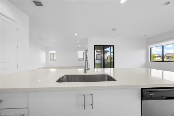 Kitchen featuring kitchen island with quartz countertops, modern cabinetry, and stainless steel appliances.