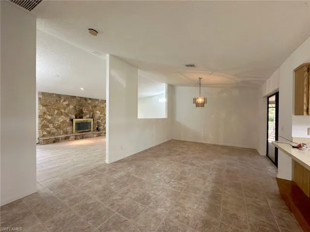 Dining area that opens onto kitchen and family room.  Remove non-bearing center wall and open space up entirely. High ceilings and fabulous floor plan!