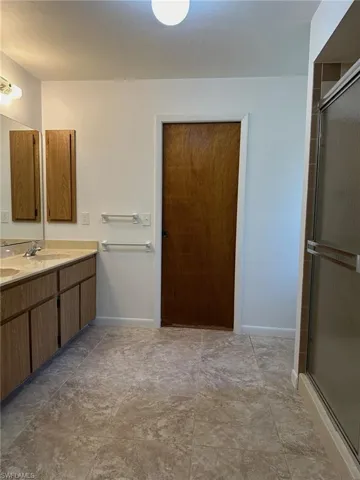 Large master bathroom with double sinks and shower.