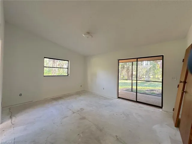 Master bedroom with cathedral ceilings and pocket sliders opening out to lanai.