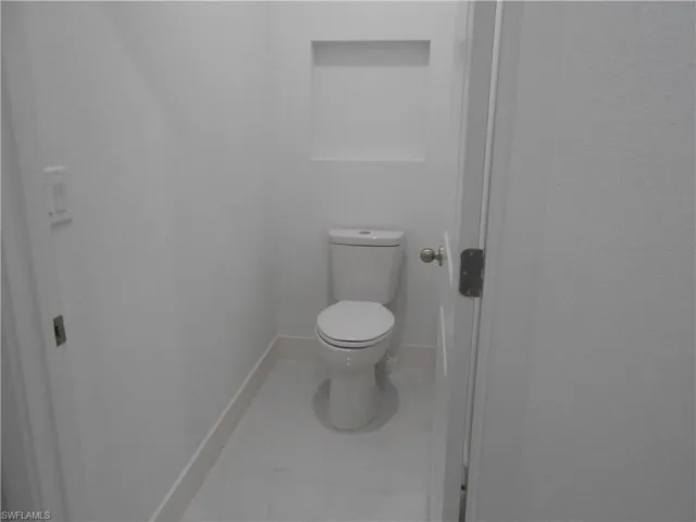 Bathroom with toilet and baseboards