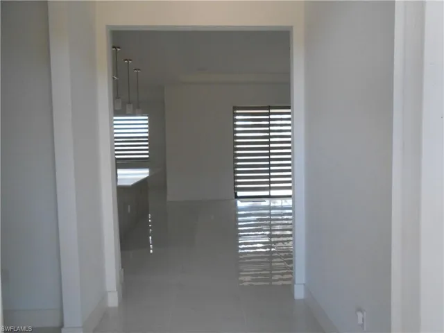 Hall with tile patterned flooring