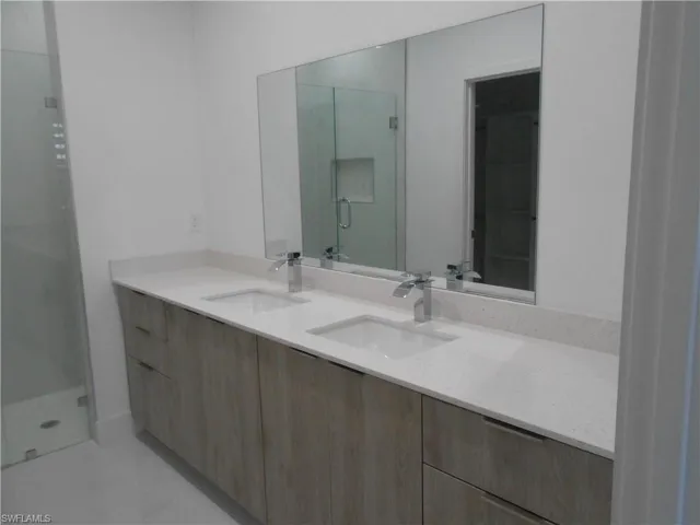 Full bath with a stall shower and double vanity