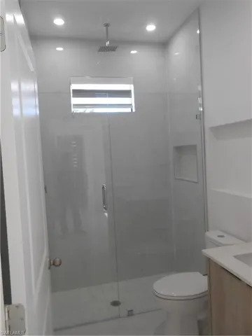 Full bath with a shower stall and toilet