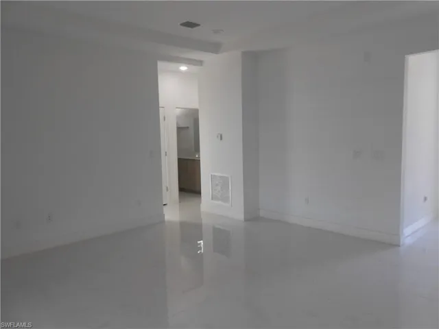 Spare room featuring baseboards