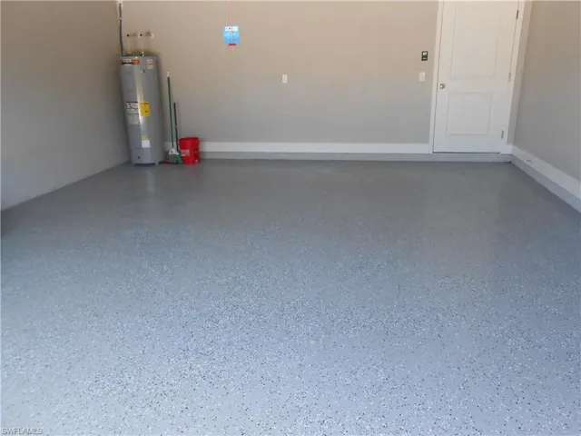 Garage featuring electric water heater
