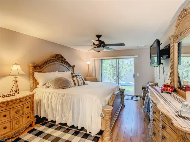 Bedroom featuring ceiling fan, hardwood / wood-style flooring, and access to exterior