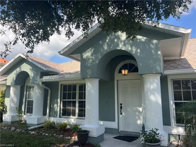 View of exterior entry with covered porch
