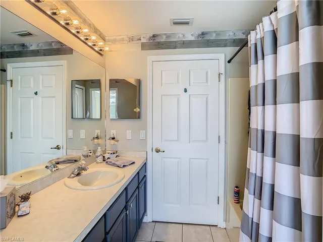 Bathroom featuring tile patterned flooring and vanity
