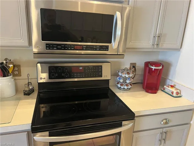 Kitchen featuring white cabinets and stainless steel appliances