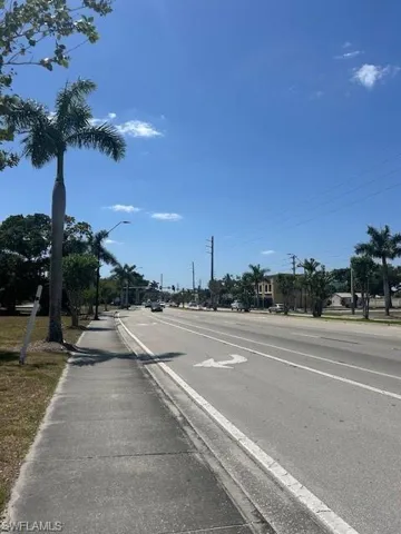 View of street featuring curbs, sidewalks, and street lighting