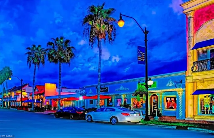 View of asphalt street with street lights and curbs