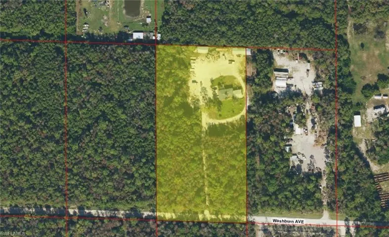 Aerial view showcasing a rectangular parcel with a cleared section, partially covered in dense tree canopy