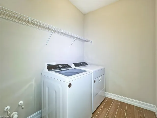 Laundry area featuring wood tiled floors and washer and dryer