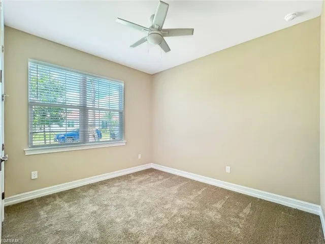 Spare room featuring carpet floors and ceiling fan