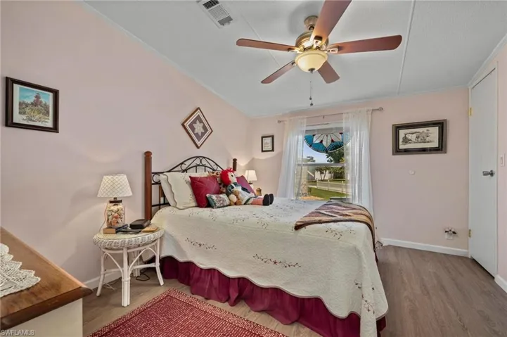 Bedroom featuring wood finished floors, ceiling fan, and crown molding
