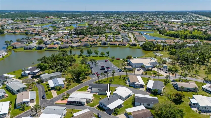 Aerial perspective of suburban area featuring a large body of water