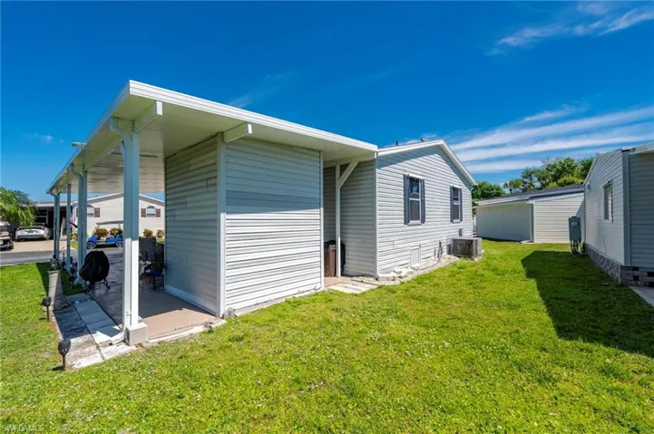 View of side of home featuring a lawn