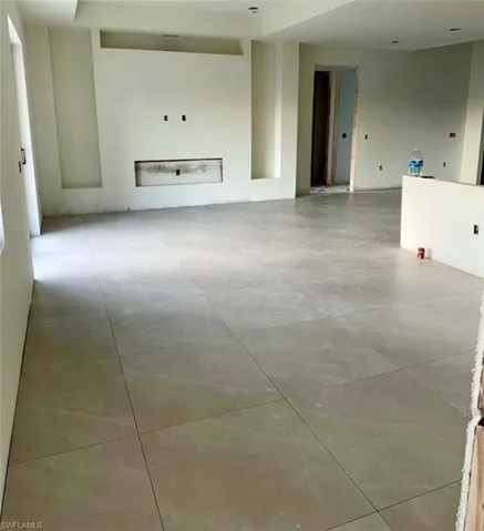 Spare room with light tile patterned flooring