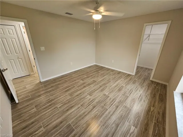 Spare room featuring ceiling fan and hardwood / wood-style flooring