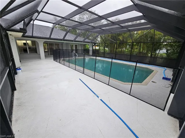 View of pool with a lanai and a patio area