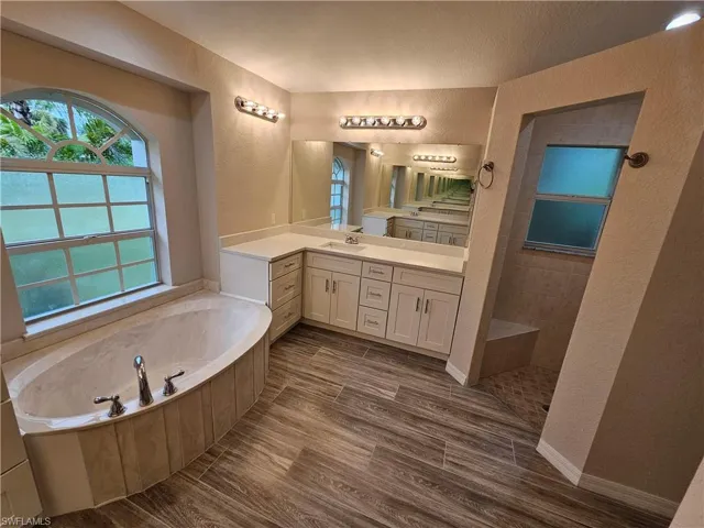 Bathroom with double sink vanity and a tub