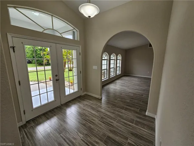 Doorway to outside featuring french doors and dark hardwood / wood-style flooring