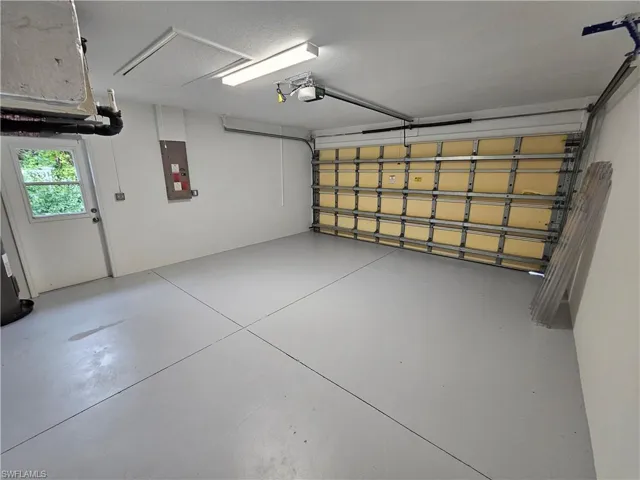 Garage with a garage door opener and electric panel