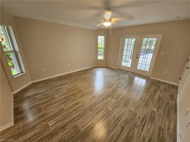 Spare room with ceiling fan, french doors, and hardwood / wood-style flooring