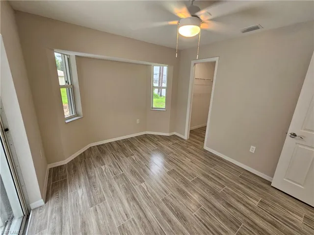 Unfurnished bedroom featuring hardwood / wood-style flooring