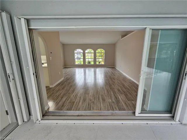 Hall with hardwood / wood-style flooring